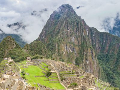 Machupicchu ancient Inca city in the Andes Mountains, showcasing its iconic terraces and stone structures against a backdrop of lush greenery.